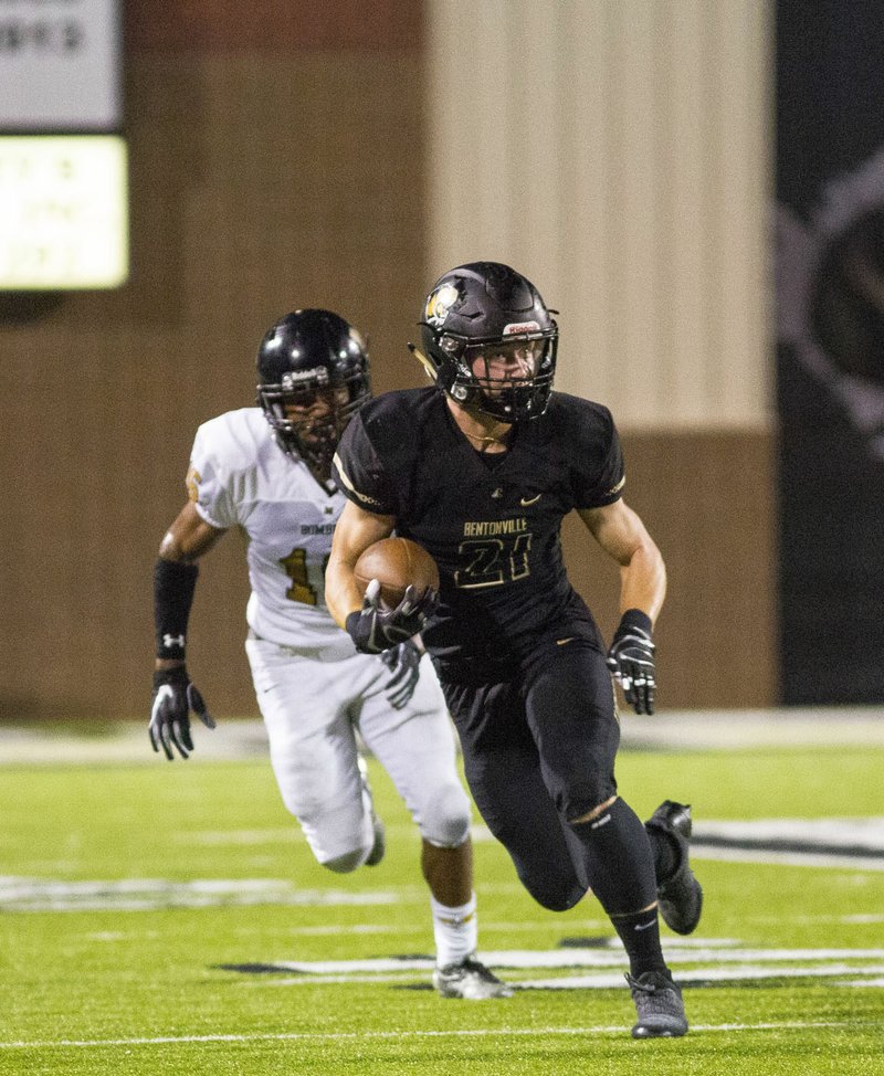 Harrison Campbell of Bentonville High runs with the ball after a catch as Midwest City, Okla. defender tries to catch him at Tiger Stadium on Saturday, August 25, 2018. Campbell has been a key playmaker for the Tigers this season as a receiver and special teams player. The Tigers travel to Van Buren tonight in a key 7A-West Conference game. Special to NWA Democrat-Gazette/ David Beach