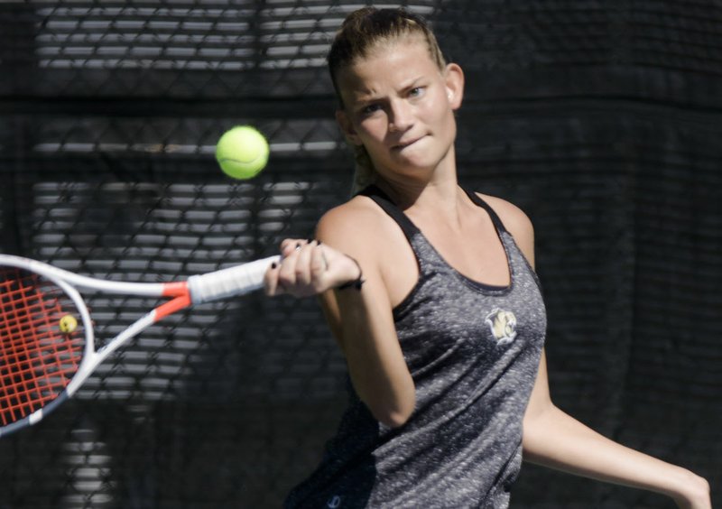 NWA Democrat-Gazette/CHARLIE KAIJO Bentonville High School's Lucia Canigova swings during the 6A-West Conference tennis tournament, Thursday, September 27, 2018 at Memorial Park tennis courts in Bentonville.