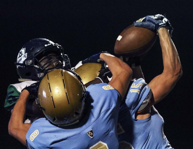 Pulaski Academy defensive backs Zach White (front) and Clay James break up a pass intended for Little Rock Christian wide receiver Chris Hightower during the Bruins’ 56-14 victory over the Warriors on Friday. For more high school football photos, visit arkansasonline.com/galleries.
