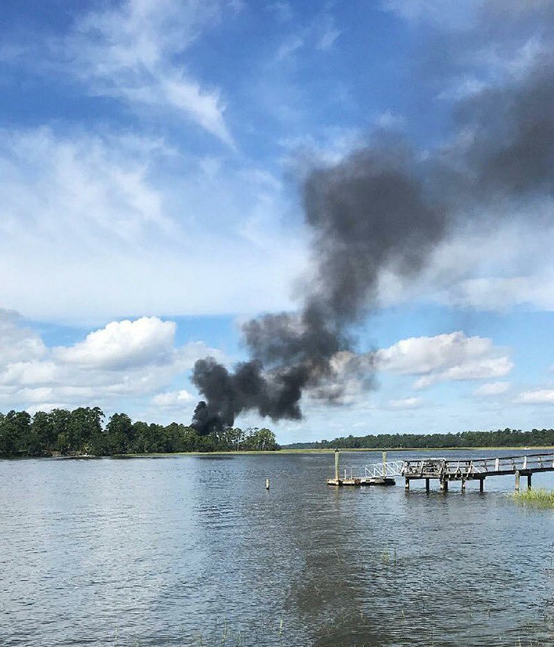 Smoke billows at the site where a military jet crashed Friday in Beaufort, S.C., near its base. 