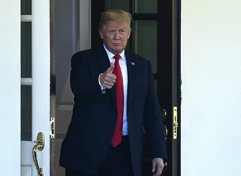 President Donald Trump watches Chilean President Sebastian Pinero leave the White House after a visit Friday. Trump also signed a spending bill Friday that averted a government shutdown. 