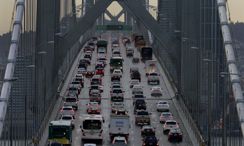  In this Dec. 10, 2015 file photo, vehicles make their way westbound on Interstate 80 across the San Francisco-Oakland Bay Bridge as seen from Treasure Island in San Francisco.  (AP Photo/Ben Margot, File)