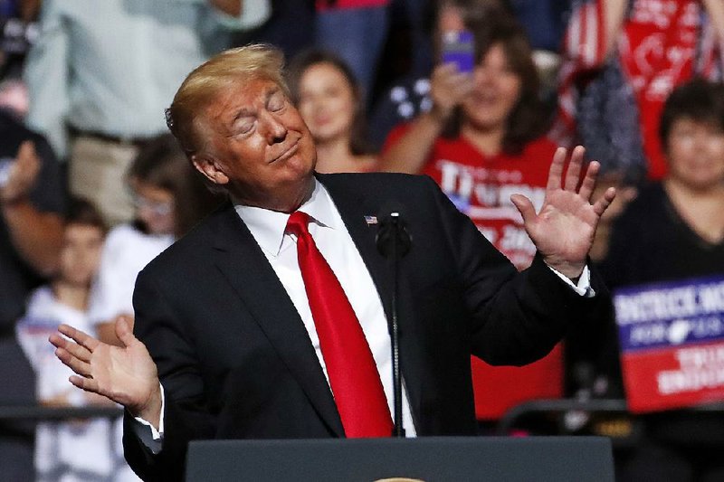 President Donald Trump sways along to the playing of West Virginia’s state song as he takes the stage Saturday for a campaign rally in Wheeling. 