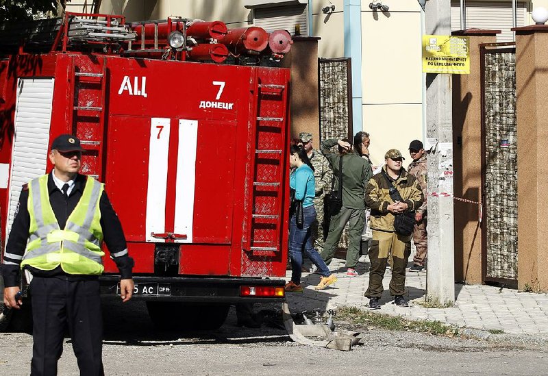 Investigators work Saturday at the site of an explosion in Donetsk, Ukraine, that wounded four people. 