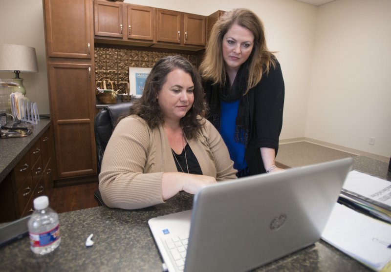 NWA Democrat-Gazette/J.T. WAMPLER Ladonna Humphrey (RIGHT) at her office in Bentonville with colleague Kimberly Williams Monday Sept. 24, 2018.