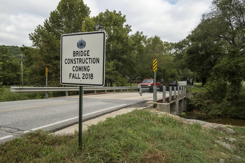 NWA Democrat-Gazette/SPENCER TIREY A sign at the Spanker Creek Bridge near Bella Vista shows it will soon be under construction. Benton County about to hold construction meetings on the bridge's replacement and work will close the road for six months or more. Which will detour school traffic and drivers who use the road as a shortcut between Bella Vista and Bentonville.