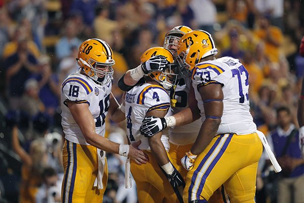 LSU running back Nick Brossette (4) is congratulated by teammates after his touchdown carry in the first half of an NCAA college football game against Mississippi in Baton Rouge, La., Saturday, Sept. 29, 2018. (AP Photo/Gerald Herbert)

