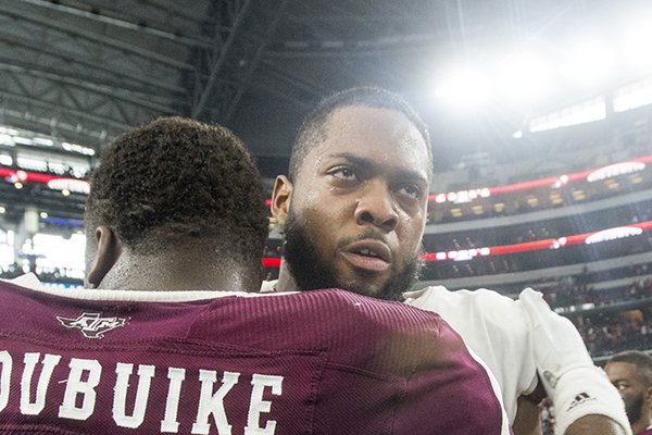 Brian Wallace, Arkansas offensive lineman, greets Justin Madubuike, Texas A&M defensive lineman, after the game Saturday, Sept. 29, 2018, during the Southwest Classic at AT&T Stadium in Arlington, Texas.