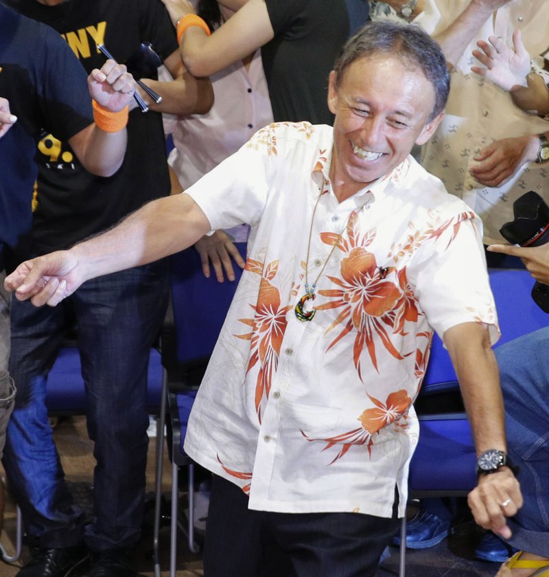 Japan's legislator Denny Tamaki celebrates his victory, dancing with supporters in the election for Okinawa governor in Naha city, Sunday, Sept 30, 2018. Tamaki, who campaigned criticizing the American military presence on the southwestern Japanese islands of Okinawa, won the election for governor Sunday, defeating a ruling party-backed candidate pushing the status quo.(Takuto Kaneko/Kyodo News via AP)