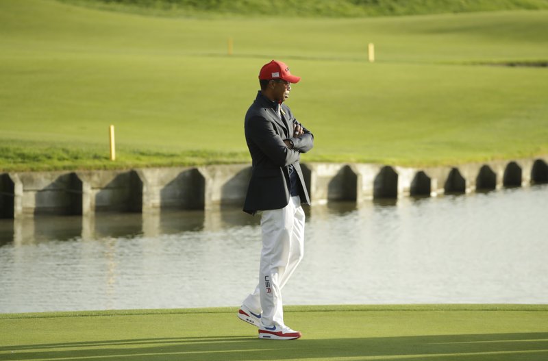 Tiger Woods of the US attends the closing ceremony after Europe won the Ryder Cup on the final day of the 42nd Ryder Cup at Le Golf National in Saint-Quentin-en-Yvelines, outside Paris, France, Sunday, Sept. 30, 2018. (AP Photo/Matt Dunham)