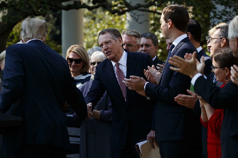 President Donald Trump shakes hands with U.S. Trade Representative Robert Lighthizer during a news conference on the trade agreement among the United States, Canada and Mexico, and the nomination of Judge Brett Kavanaugh to the Supreme Court, in the Rose Garden of the White House on Monday in Washington.