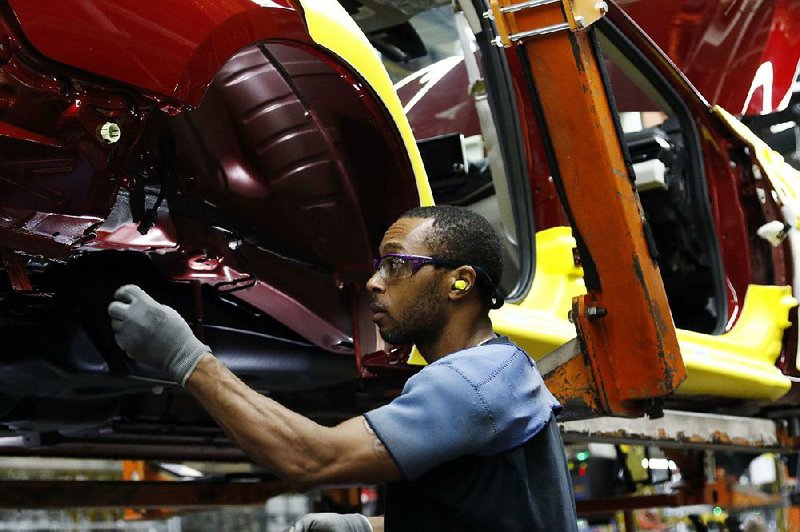 A line technician assembles a redesigned Nissan Altima sedan Thursday at a plant in Canton, Miss. U.S. manufacturing growth slowed in September amid with worker shortages, trade tariffs and rising prices for raw materials, the institute for Supply Management said Monday.