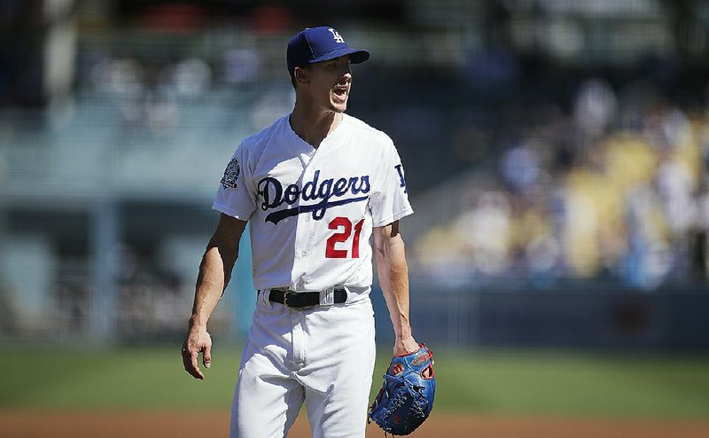 Los Angeles Dodgers starting pitcher Walker Buehler shouts as he leaves the mound after the first inning of a tiebreaker baseball game against the Colorado Rockies.