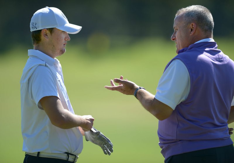 NWA Democrat-Gazette/ANDY SHUPE Fayetteville senior golfer Denver Davis (left) speaks Thursday, Sept. 27, 2018, with Bulldogs coach Scott Williams during practice at Fayetteville Country Club. The Bulldogs will be going for their sixth straight state championship today in the Class 6A state tournament in Cabot.