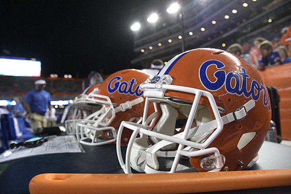 Florida helmets sit next to the bench during the second half of an NCAA college football game against Charleston Southern Saturday, Sept. 1, 2018, in Gainesville, Fla. Florida won 53-6. (AP Photo/Phelan M. Ebenhack)

