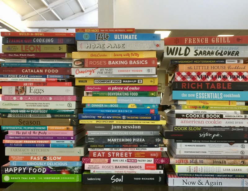 Stacks upon stacks of cookbooks cover Food editor Kelly Brant's desk.