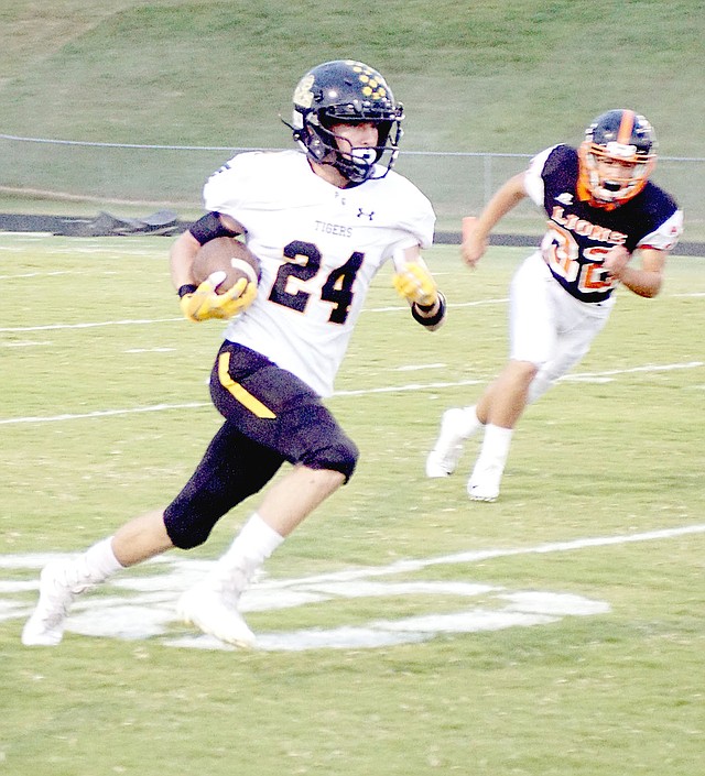 RANDY MOLL NWA NEWSPAPERS Prairie Grove senior Jacob Watson took a lateral from Jackson Sorters and returned the opening kickoff 87 yards for a touchdown to begin the Tigers' 42-0 rout of Gravette Friday. Prairie Grove had three scoring plays of better than 85 yards during the contest.