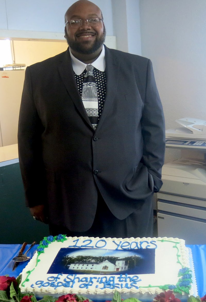 Westside Eagle Observer/SUSAN HOLLAND Donald Miller, pastor of First Christian Church in Gravette, poses with a cake celebrating "120 years of sharing the gospel of Jesus" at the church's anniversary celebration Sat., Sept. 29. Miller is the forty-eighth pastor in the church's history.