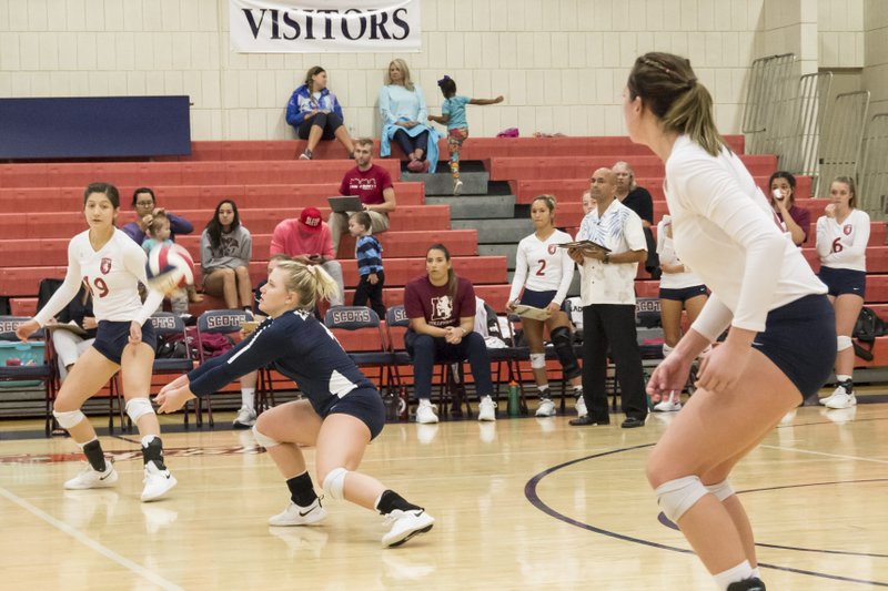 Submitted photo DEFENSE ON DISPLAY: Lyon senior libero Madisson Williams, center, makes a dig in a recent match for the Scots. Williams leads the team in digs and digs per set after earning her second American Midwest Conference Defensive Player of the Week award of the season.