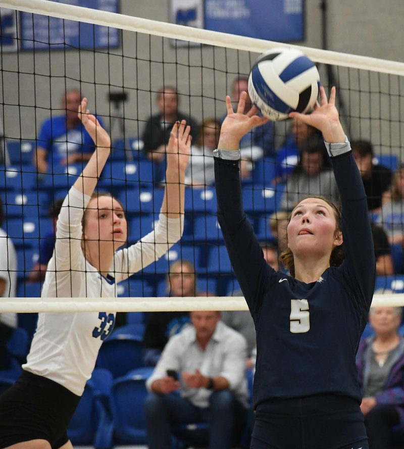 NWA Democrat-Gazette/J.T. WAMPLER Bentonville West's Winnie Spurlock sets the ball while Rogers' Ryley Martin defends Tuesday Oct. 2, 2018 at Rogers. West won three straight sets 25-23, 25-16, 25-23.