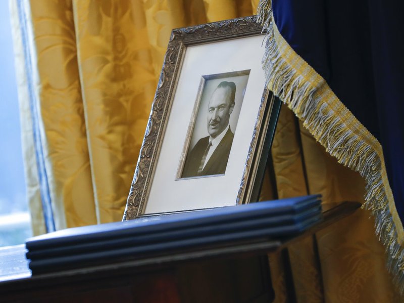 In this Feb. 9, 2017, file photo, a portrait of President Donald Trump's father, Fred Trump, and three un-signed Executive orders are seen in the Oval Office of the White House in Washington. 