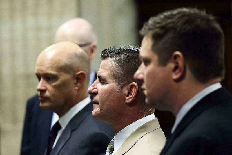 Police officer Jason Van Dyke (light-colored suit) stands with his attorneys Wednesday during his Chicago trial in the 2014 shooting death of Laquan McDonald. 