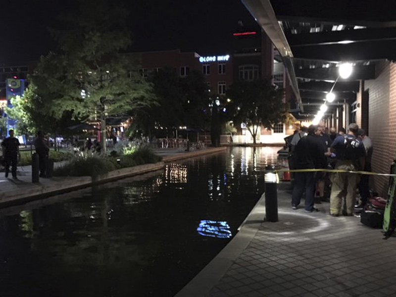 This photo provided by the Oklahoma City Fire Department, shows the scene at the Bricktown canal in Oklahoma City, Sunday, Sept. 30, 2018, where one man died and another is in critical condition after being electrocuted in the canal. (Oklahoma City Fire Department via AP)