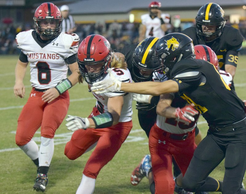 RICK PECK/SPECIAL TO MCDONALD COUNTY PRESS McDonald County's Marshall Foreman (5) follows the blocking of teammate Reece Cooper (13) for a nice gain during the Mustangs' 37-6 loss on Sept. 28 at Cassville High School.