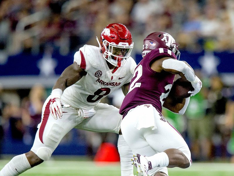 NWA Democrat-Gazette/Ben Goff MIDDLE MAN: Arkansas junior middle linebacker De'Jon "Scoota" Harris (8) prepares to tackle Texas A&amp;M running back Kwame Etwi Saturday during the Razorbacks' 24-17 loss to the Aggies in the annual Southwest Classic at the Dallas Cowboys' AT&amp;T Stadium in Arlington, Texas.