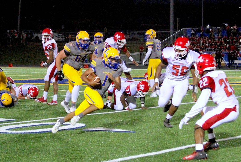 The Sentinel-Record/Jami Smith LEADING RUSHER: Lakeside sophomore running back Isaac Echols attacks the Magnolia defense Friday at Chick Austin Field during the Rams’ 71-48 victory. Echols had 173 yards in the game and leads the team with 535 yards this season.