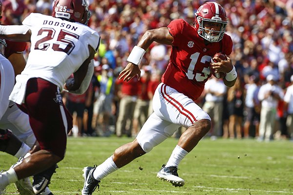 Alabama quarterback Tua Tagovailoa (13) scrambles for a first down against Texas A&M during the first half of an NCAA college football game, Saturday, Sept. 22, 2018, in Tuscaloosa, Ala. (AP Photo/Butch Dill)

