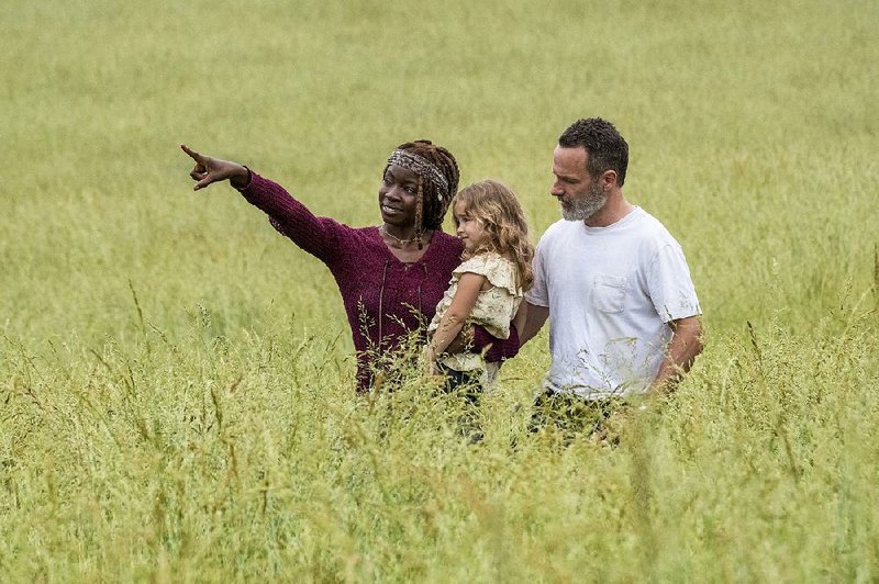 Happier days? This idyllic scene from the new season of The Walking Dead would suggest post-apocalyptic peaceful times ahead. Don’t bet on it. Shown are (from left) Danai Gurira as Michonne, Chloe Garcia as Judith and Andrew Lincoln as Rick Grimes.
