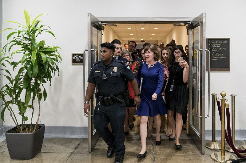 Reporters trail GOP Sen. Susan Collins Thursday after she leaves the secure room where the FBI report on Supreme Court nominee Brett Kavanaugh was displayed. Collins, who said she will announce her vote today on Kavanaugh, called the FBI’s work “a very thorough investigation.” 