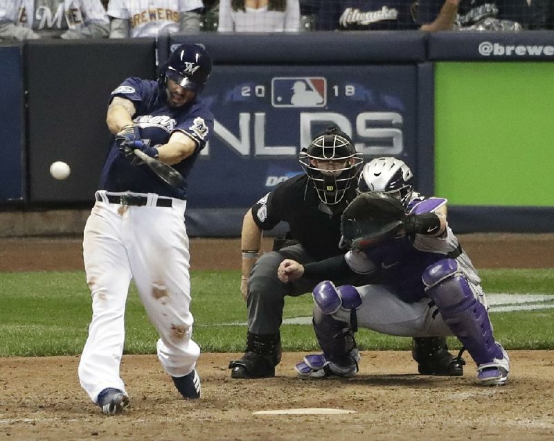 Mike Moustakas hits a walk-off single in the 10th inning to lift the Milwaukee Brewers to a 3-2 victory over the Colorado Rockies on Thursday in the opening game of the National League division series in Milwaukee.