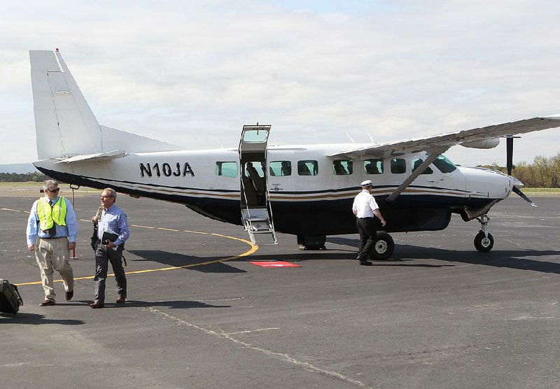 A Southern Airways employee and passenger walk at Hot Springs Memorial Field in this 2017 file photo. The federal Essential Air Service Program helps airlines like Southern Airways provide service to the state’s smaller airports. 
