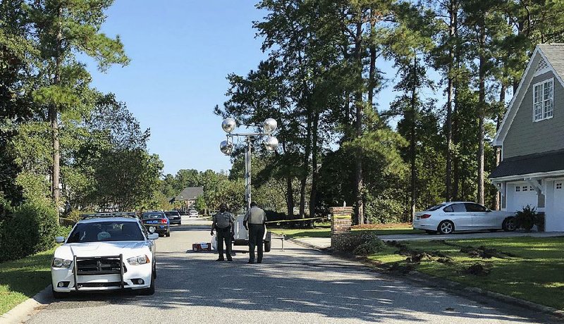Police patrol the area Thursday in Florence, S.C., where seven law enforcement officers were shot the day before. 