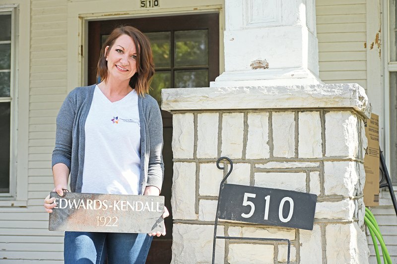 Lindsey Carter, executive director of the new Child Advocacy Center of Independence County, holds a sign original to the house, built in 1922, at 510 E. Boswell St. in Batesville. The advocacy center is a first for the community, and an open house is scheduled for 11 a.m. Nov. 13. “We bought a house in downtown Batesville for a reason; it’s a safe, homey environment,” Carter said. The home is on the National Register of Historic Places.