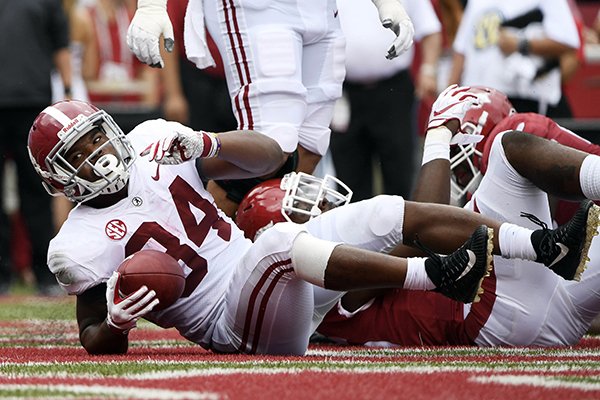 Alabama running back Damien Harris scores a touchdown against Arkansas in the first half of an NCAA college football game Saturday, Oct. 6, 2018, in Fayetteville, Ark. (AP Photo/Michael Woods)


