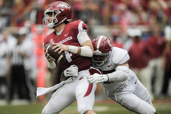 Arkansas quarterback Ty Storey is hit by Alabama linebacker Christian Miller during a game Saturday, Oct. 6, 2018, in Fayetteville. 