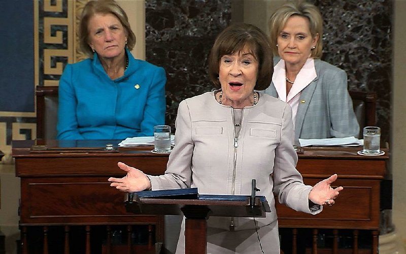 Sen. Susan Collins, R-Maine, speaks on the Senate floor about her decision to vote for Supreme Court nominee Brett Kavanaugh. Republican Sen. Shelly Capito (left) and Sen. Cindy Hyde-Smith are in the background. 