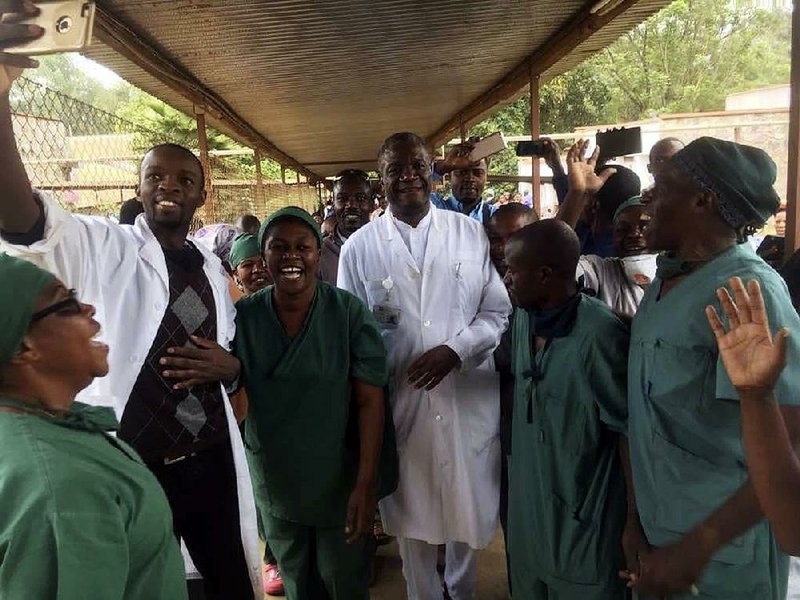 Denis Mukwege (center) celebrates his Nobel Peace Prize award with the staff Friday at his Panzi Hospital in Bukavu, Congo, where he has treated many rape victims. 