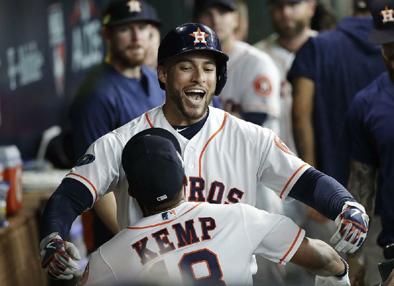 The Houston Astros’ George Springer celebrates after his home run in the fifth inning of Friday’s 7-2 victory over the Cleveland Indians in the American League division series. Eddie Flores, an Astros fan, predicted that if Springer hit a home run in the fifth inning, he would buy everyone in his section a beer. The bet cost Flores $300.