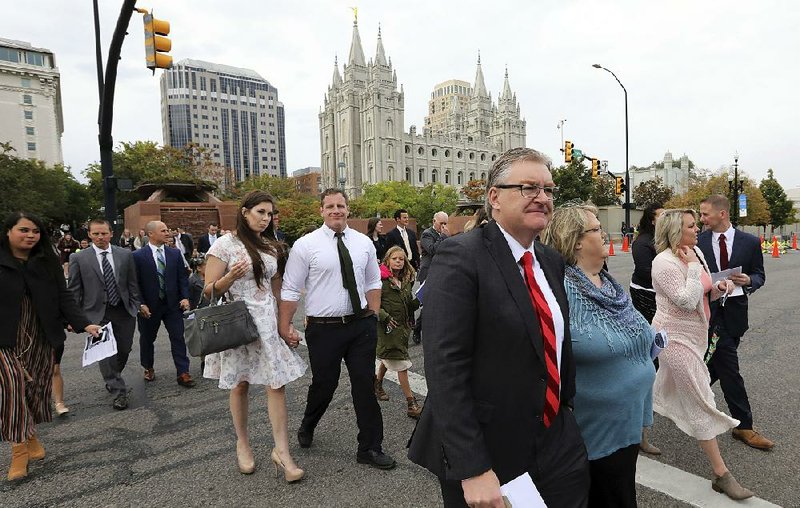 Attendees arrive Saturday at a conference in Salt Lake City for The Church of Jesus Christ of Latter-day Saints.