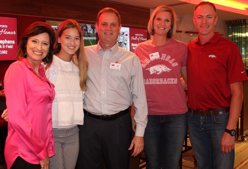 NWA Democrat-Gazette/CARIN SCHOPPMEYER Stephanie Horne (from left), Caroline Horne, Greg Horne and Kim Storey Chronister and Graham Chronister gather Sept. 13 at the University of Arkansas Sports Hall of Honor reception at Donald W. Reynolds Razorback Stadium in Fayetteville.