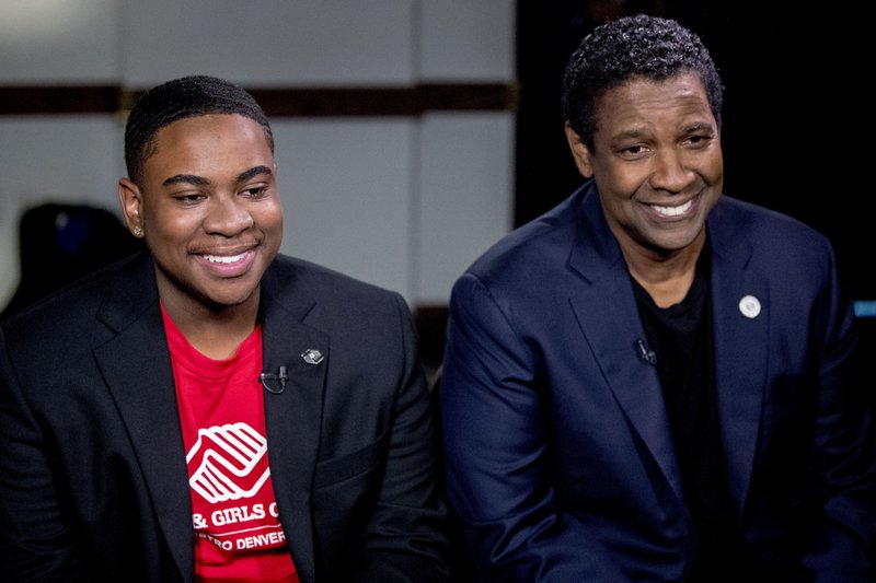 FILE - In this Sept. 26, 2018 file photo, actor Denzel Washington, right, and Malachi Haynes appear at an interview with Fox News Anchor Chris Wallace at the National Press Club in Washington. The Boys &amp; Girls Clubs of America named Haynes the Southwest Youth of the Year. The organization, which began in 1860, offers a positive alternative to children than roaming the street. Washington, who joined when he was 5, is a national spokesman for the organization. (AP Photo/Andrew Harnik, File)