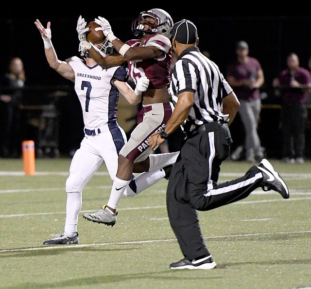 Bud Sullins/Special to Siloam Sunday Siloam Springs senior wide receiver Primo Agbehi hauls in a 53-yard touchdown pass from Landon Ellis as Greenwood's Dawson James defends on the play during Friday's game at Panther Stadium. Greenwood defeated Siloam Springs 42-7.