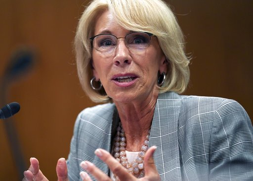 FILE - In this June 5, 2018, file photo, Education Secretary Betsy DeVos testifies during hearing on the FY19 budget on Capitol Hill in Washington. A little-known venture capitalist is on the verge of acquiring one of the country's biggest for-profit colleges, a transaction that would put him in control of a troubled national chain vastly larger than the tiny California school he currently owns.(AP Photo/Carolyn Kaster, File)