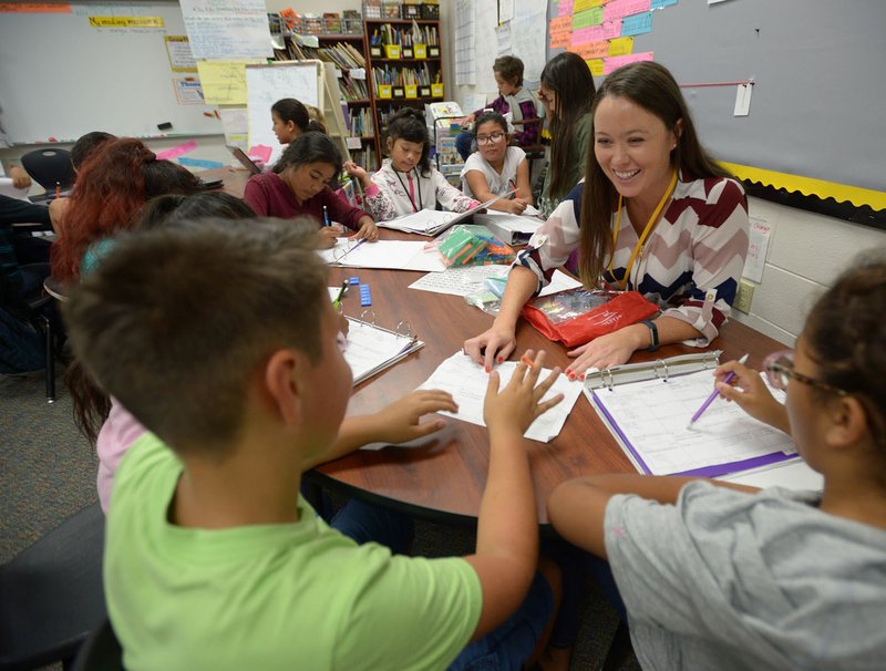 NWA Democrat-Gazette/ANDY SHUPE Vanessa Stewart, a fourth-grade teacher at Monitor Elementary School in Springdale, works with students Tuesday on a lesson about fractions during class at the school. Stewart is one of four finalists for Teacher of the Year in the state.