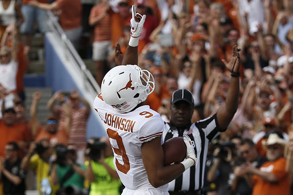 Texas Longhorn wide receiver Collin Johnson celebrates after a touchdown reception during the first half of an NCAA college football game against the Oklahoma Sooners, Saturday, Oct. 6, 2018, in Dallas, Texas. (AP Photo/Roger Steinman)
