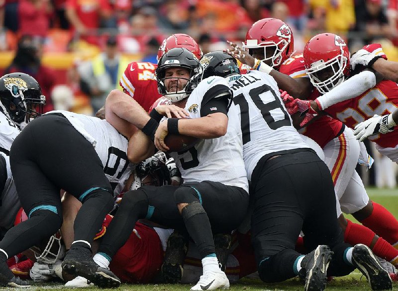 Jacksonville Jaguars quarterback Blake Bortles (5) is surrounded by Kansas City Chiefs defenders during the second half Sunday in Kansas City, Mo. The Chiefs improved to 5-0 as their defense picked off Bortles four times and sacked him five times in a 30-14 victory.